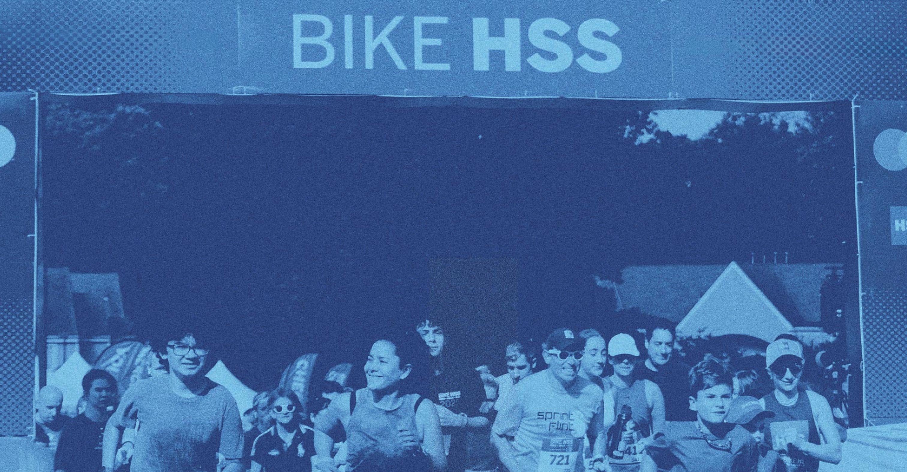 Blue toned photograph showing 5K participants crossing the finish line during last year's event.