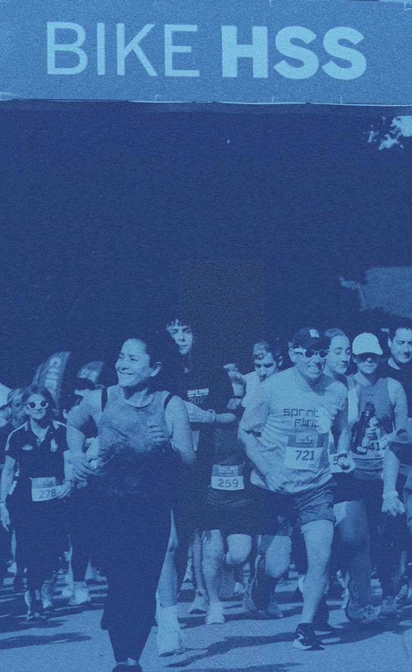 Blue toned photograph showing 5K participants crossing the finish line during last year's event.
